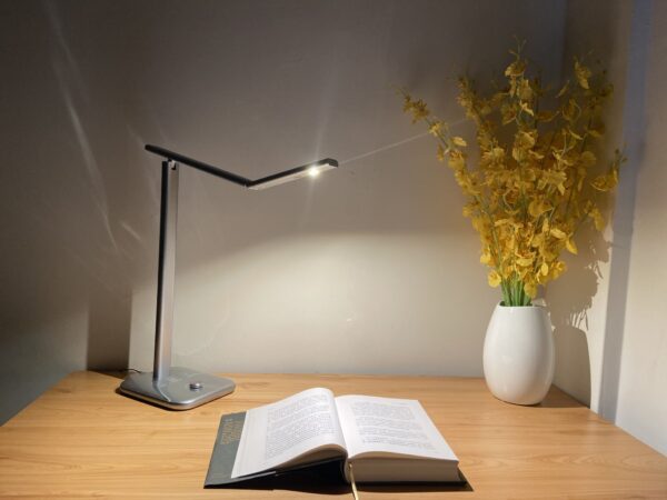 A table lamp beside an open book