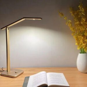 A table lamp beside an open book
