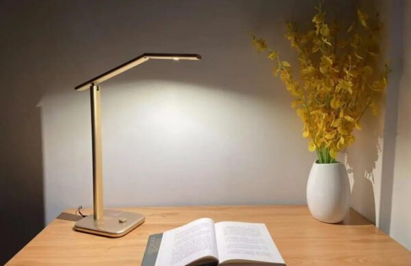 A table lamp beside an open book